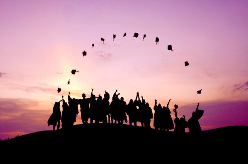 graduates tossing a cap